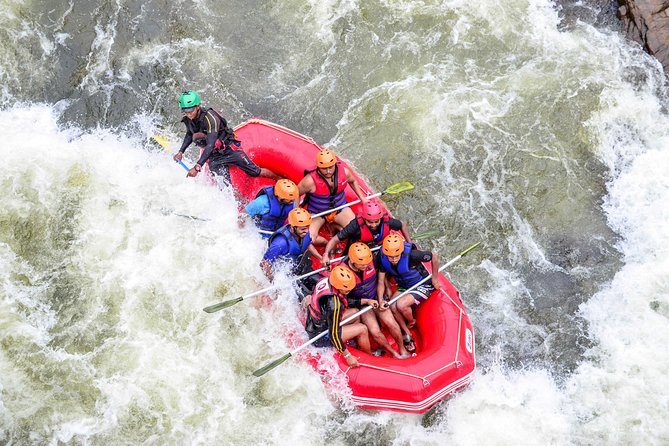 adventurers white waterrafting down a river in kitulgala.